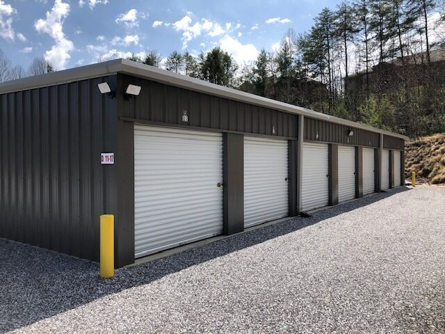 Drive-up storage units with white roll-up doors at an Incredible Storage facility